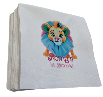 White napkins with a colourful lion character and 'Romy's 1st Birthday'