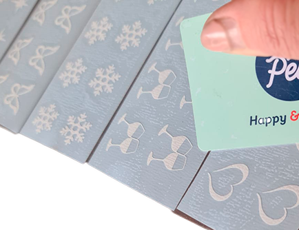 Use a card to rub down the application tape to the stickers.