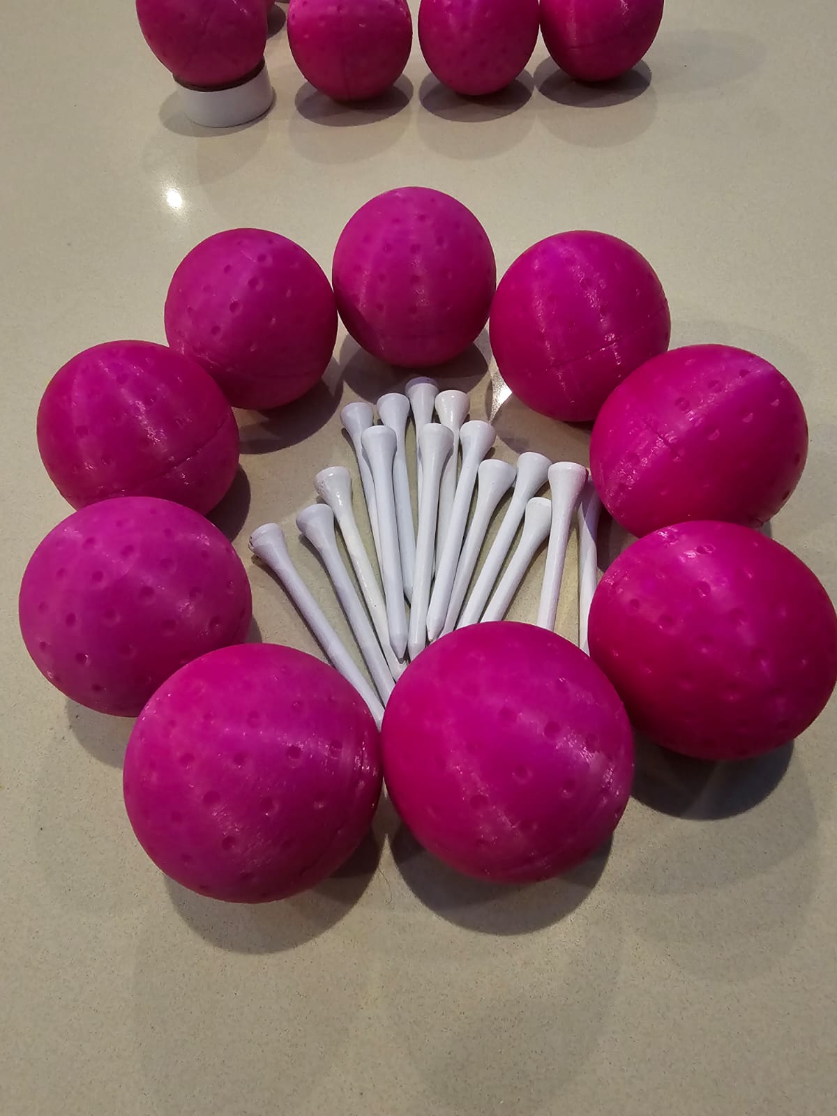 Pink golf balls filled with pink powder